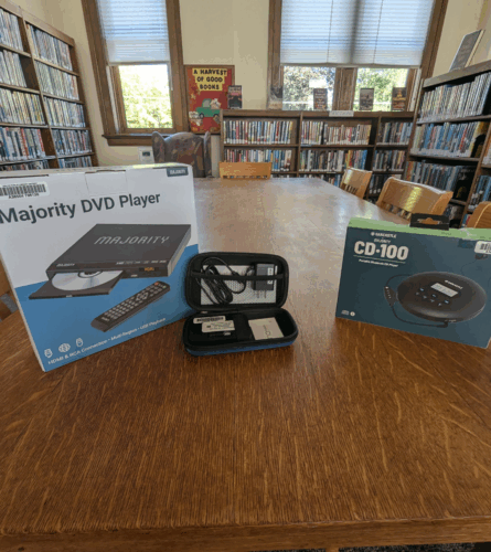 DVD player, Wifi Hotspot, CD Player with books on shelves in the background
